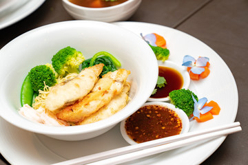 Fried fish Thai Nooble style in white bowl ready to serve and eat fot lunch or dinner.