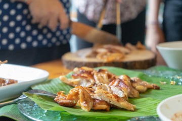 Siled roasted chicken on bana leaf ready to serve and eat.