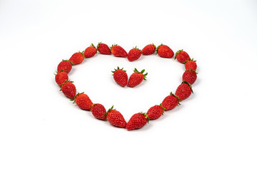 Heart shape of strawberries in the line. Red fresh strawberry in studio light on the pure white background.