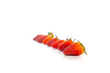 Fresh luxury Strawberry are arranged in the row and column with studio light on the white background.