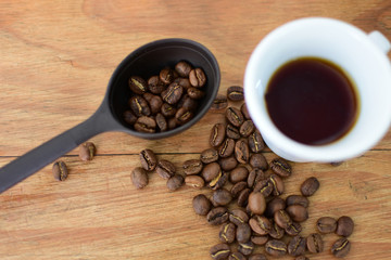 coffee beans, accompanied by cup of hot coffee