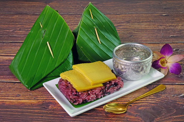 Traditional Thai dessert : Sweet Purple Sticky rice with Thai egg custard. Selective focus.