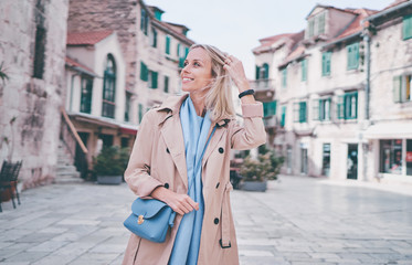 Fototapeta premium Traveling by croatia. happy young woman in coat walking by Split Old Town.