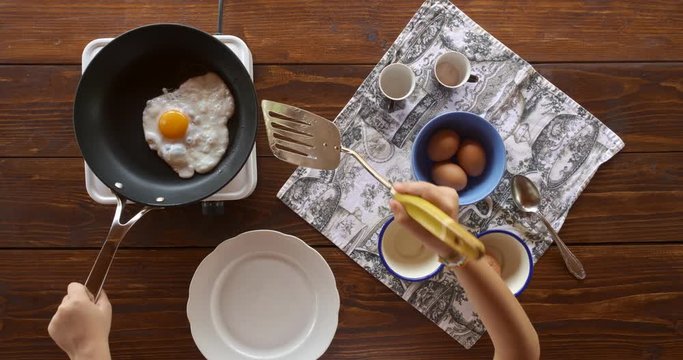 Top view food. Cooking With Mother. Beautiful Little Girl Learns How To Make Fried Egg.