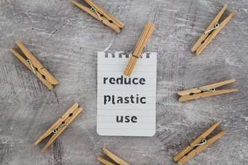 Reduce plastic use message with wooden pegs to hang the washing, sustainable living