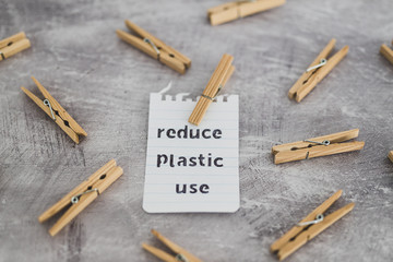 Reduce plastic use message with wooden pegs to hang the washing, sustainable living