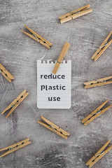 Reduce plastic use message with wooden pegs to hang the washing, sustainable living