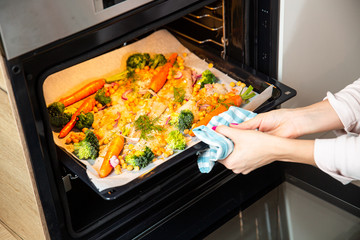 carrots, broccoli, chickpeas, fish fillets, onions and spices baked in the oven