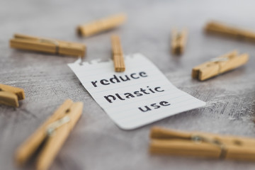 Reduce plastic use message with wooden pegs to hang the washing, sustainable living