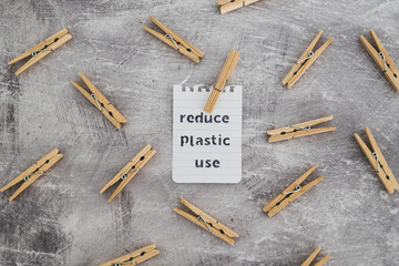Reduce plastic use message with wooden pegs to hang the washing, sustainable living