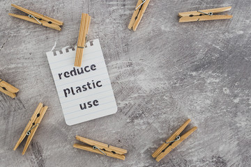 Reduce plastic use message with wooden pegs to hang the washing, sustainable living