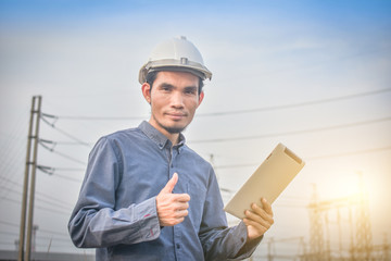 Electrical engineer uses a tablet to inspect Power plant network For power generation