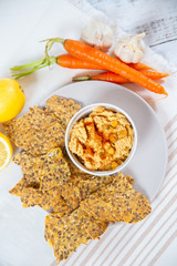 hummus and chips with black and white sesame 
