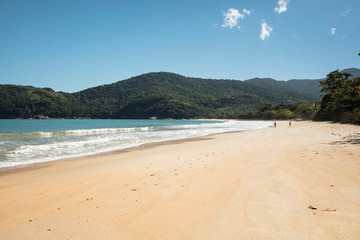 Beautiful Parnaioca beach with crystal blue water and clear sand, deserted tropical beach on the sunny coast of Rio de Janeiro, Ilha Grande in the city of Agnra dos Reis, Brazil
