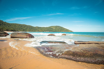 Beautiful Parnaioca beach with crystal blue water and stones, deserted tropical beach on the sunny coast of Rio de Janeiro, Ilha Grande in the city of Agnra dos Reis, Brazil