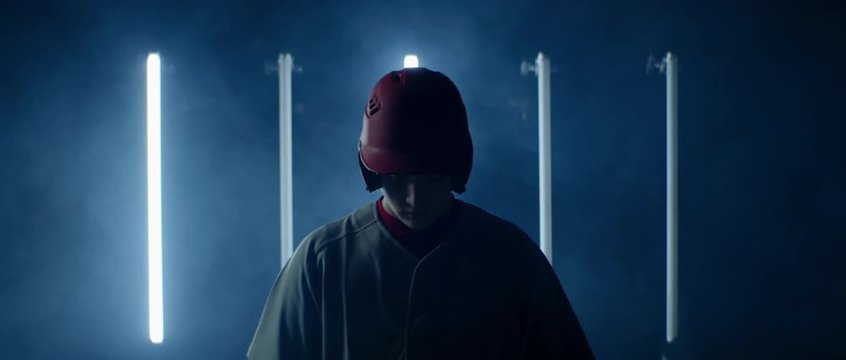 Caucasian professional baseball player batter posing against bright flashing lights. 4K UHD 60 FPS SLOW MOTION shot on ARRI Alexa Mini with Atlas Orion 2x Anamorphic lens