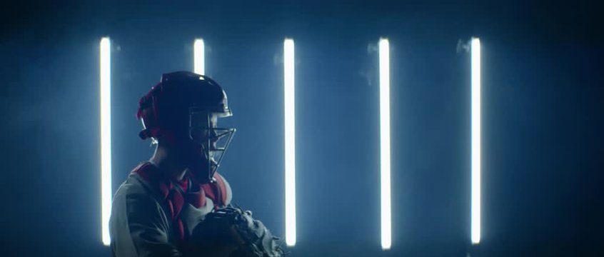 Caucasian professional baseball player catcher posing against bright lights. 4K UHD 60 FPS SLOW MOTION shot on ARRI Alexa Mini with Atlas Orion 2x Anamorphic lens