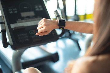 Smart watch showing a heart rate of exercising woman in gym