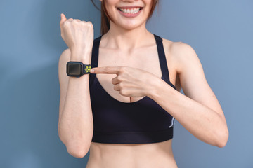 Smart watch showing a heart rate of exercising woman in gym