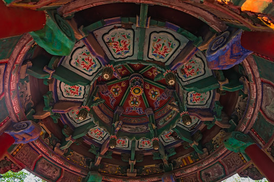 Colorful paintings on the ceiling of an altar of Buddhist temple