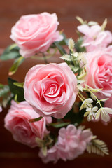 Beautiful pink roses on  the old wooden table background