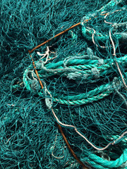 Tangled teal fishing net and rope