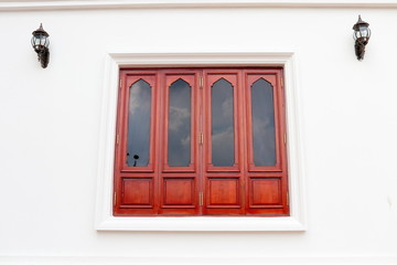 Fototapeta na wymiar Red brown wood window and white wall, retro style window is closed. 