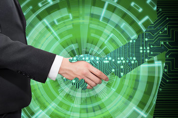 Businessman shaking hand with digital partners hand on green futuristic background.
