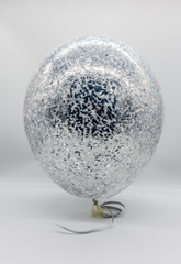 Helium balloons transparent with silver confetti. A beautiful decoration for any holiday.