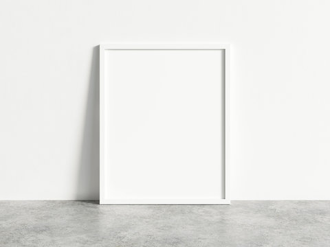 Vertical empty white frame mock up on concrete floor. Blank frame mockup. 3d illustrations.
