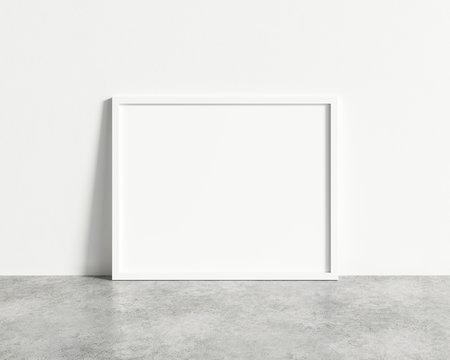 Horizontal empty white frame mock up on concrete floor. Blank frame mockup. 3d illustrations.