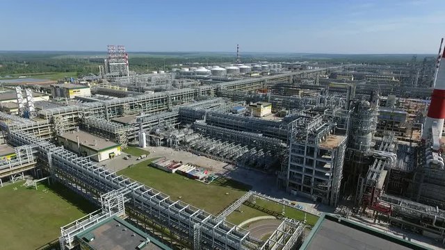 Aerial - Industrial facilities and storage tanks on the area of large oil refinery, Russia