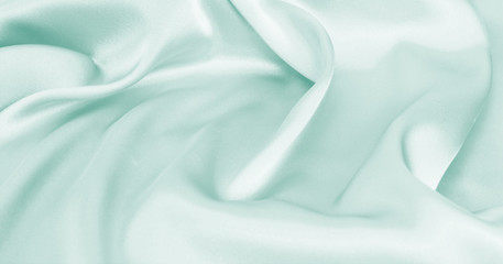 Delicate satin draped fabric of blue color texture for festive backgrounds
