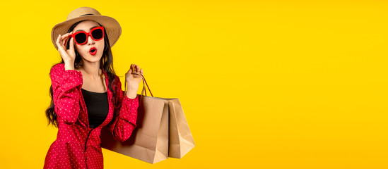 Banner of Asian trendy shopaholic woman excited about new purchases or sales holding shopping bags...