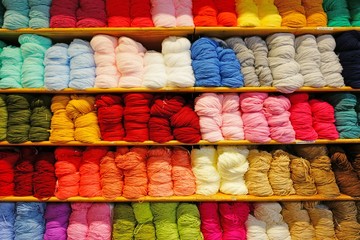 Shelves filled with colorful wool yarn spools in a knitting store