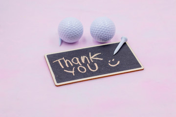 Golf thank you with golf balls and tee with thank you word on pink background