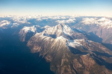 Aerial Landscape View flying over Coast Mountains of British Columbia, Canada from plane window.  Mount Judge Howay in the foreground © Autumn Sky