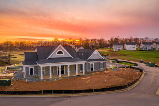 Sunset aerial view of a newly built community center pavilion club house in a American real estate development with a swimming pool