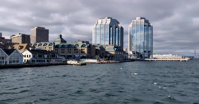 View of Halifax harbor waterfront while cruising on the choppy water beneath cloudy stormy skies