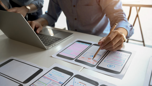 Close-up view of UI graphic designer planing his smartphone template