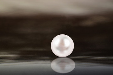 Fototapeta na wymiar Real pearls Selected, beautiful color, laying on the ground, with reflection