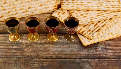 Four cups full of wine with matzah. Jewish holidays Passover.