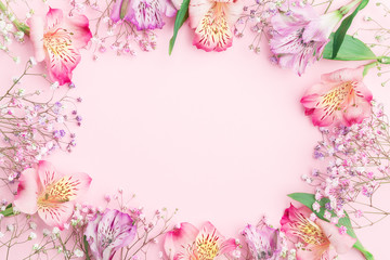 Floral composition. FLowers border frame with  gypsophila and alstroemeria. Flat lay, top view,...