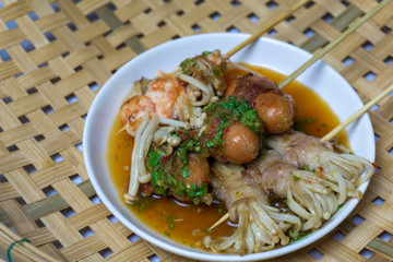 Bacon roll enoki mushroom and sausage grilled with spicy sauce