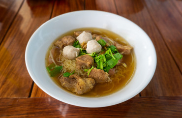 Rice noodle soup with Stewed pork in white bowlÂ 
