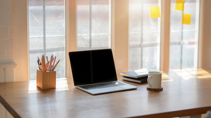 Obraz na płótnie Canvas Cropped shot of simple workplace next to window