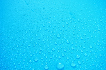 Water Drops On Blue Background.