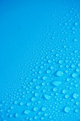 Naklejka na ściany i meble Water Drops On Blue Background.