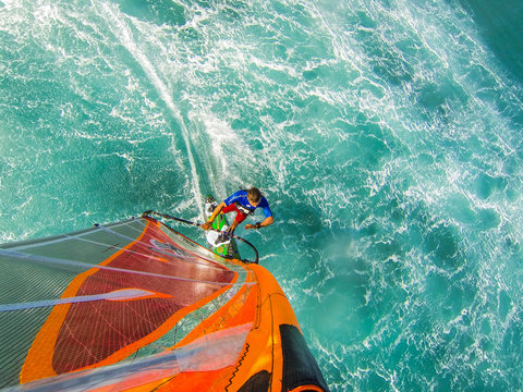 Funny windsurfing on the crystal clear waters and reef
