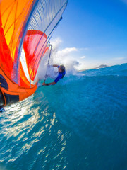 Funny windsurfing on the crystal clear waters and reef